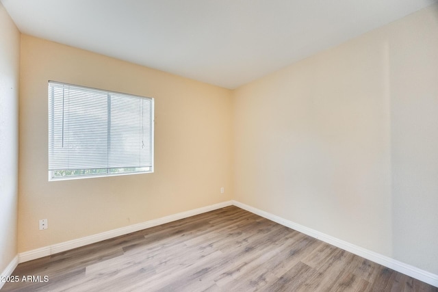 spare room featuring light hardwood / wood-style flooring