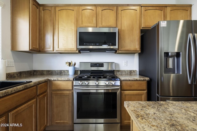 kitchen with stainless steel appliances and stone countertops