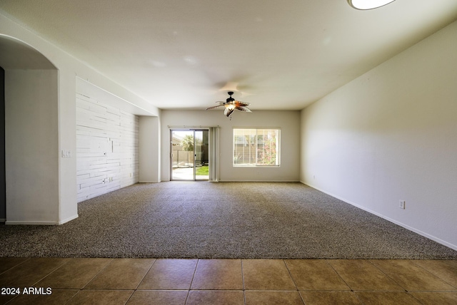 carpeted spare room featuring ceiling fan