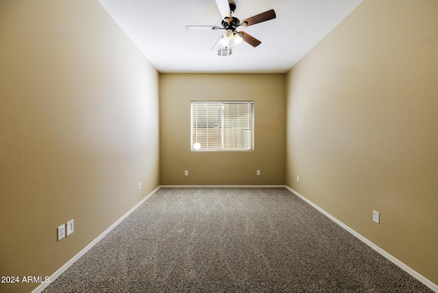 carpeted spare room featuring ceiling fan