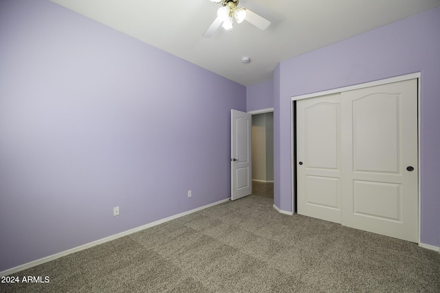 unfurnished bedroom featuring ceiling fan, a closet, and carpet