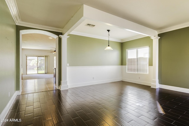 empty room with ornate columns, ceiling fan, and crown molding