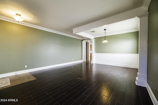 empty room with dark hardwood / wood-style flooring, ornate columns, and ornamental molding