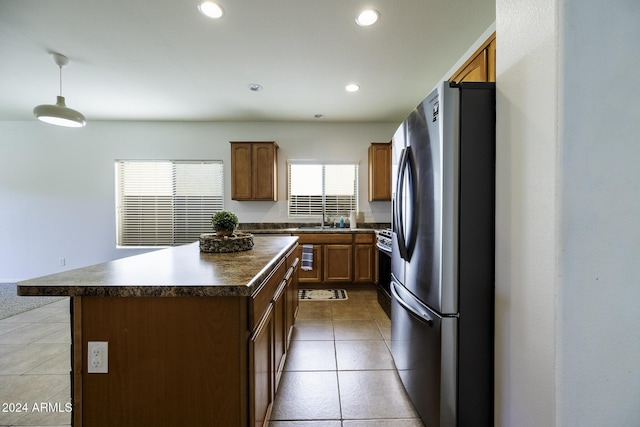 kitchen with light tile patterned flooring, a center island, stainless steel appliances, and sink