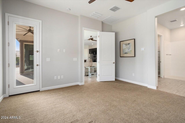 unfurnished bedroom featuring carpet flooring, ceiling fan, and access to exterior