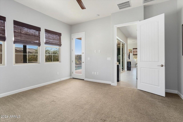 empty room featuring light carpet and ceiling fan