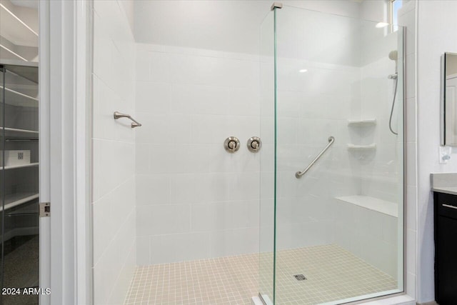 bathroom with vanity and tiled shower