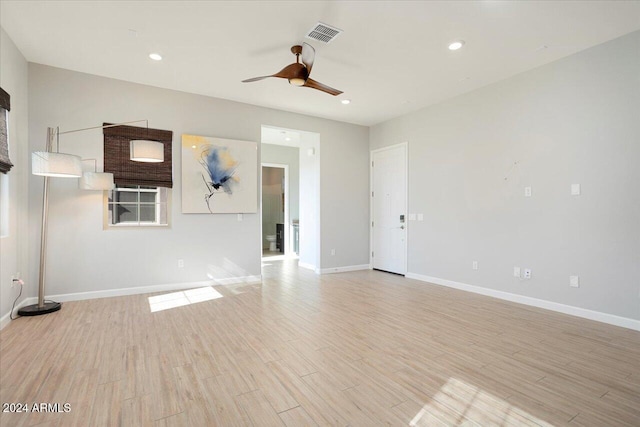 unfurnished room with light wood-type flooring and ceiling fan