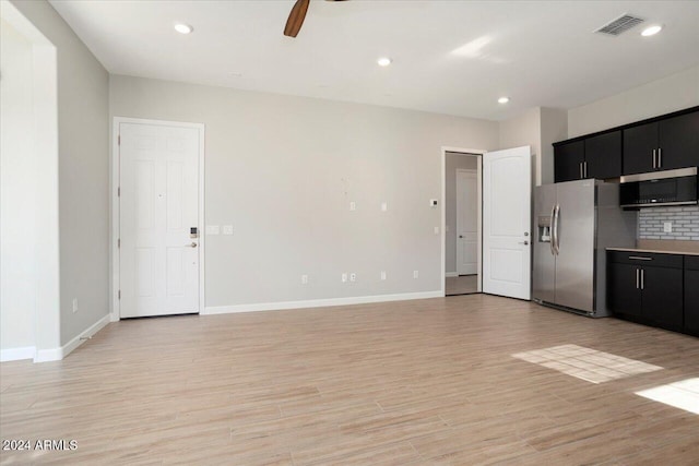 kitchen featuring appliances with stainless steel finishes, light wood-type flooring, ceiling fan, and backsplash