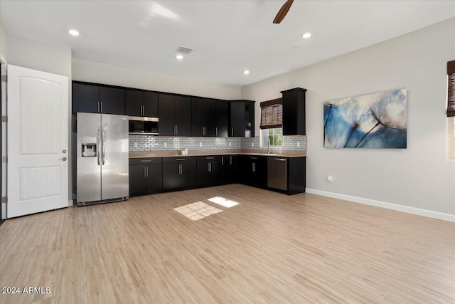 kitchen with ceiling fan, sink, stainless steel appliances, and light hardwood / wood-style flooring