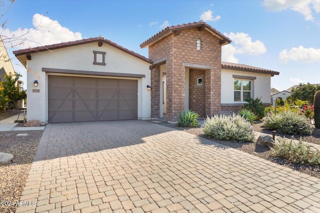 mediterranean / spanish house featuring a garage