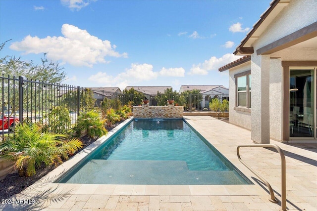 view of pool with a patio area and pool water feature