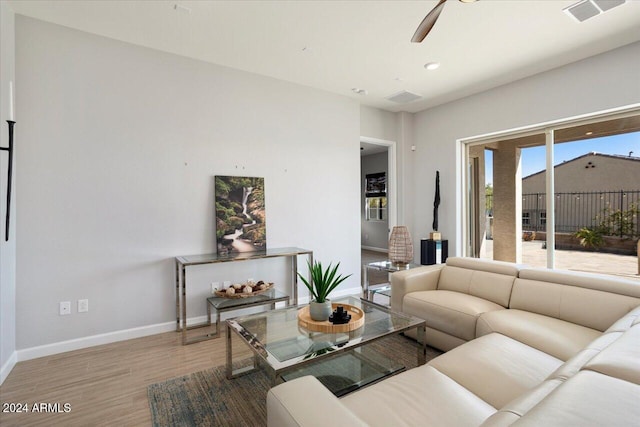 living room with hardwood / wood-style floors and ceiling fan