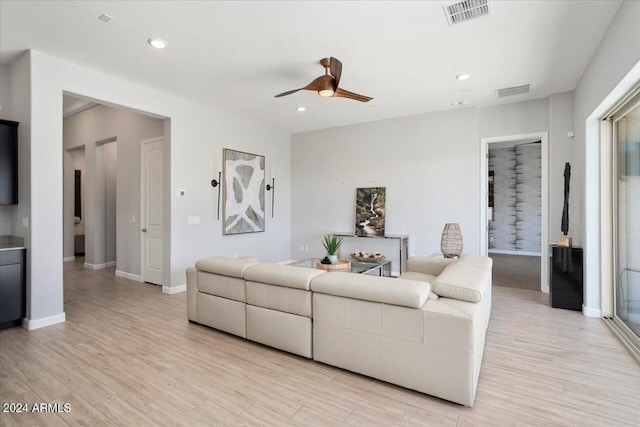 living room featuring light hardwood / wood-style floors and ceiling fan