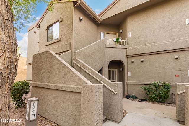 view of front of home with a patio area and stucco siding