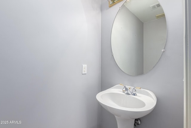 bathroom featuring visible vents and a sink