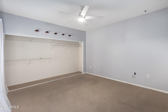 unfurnished bedroom featuring carpet floors, a closet, ceiling fan, and baseboards