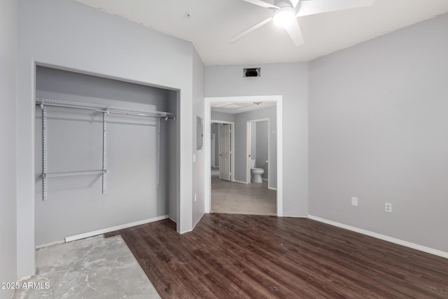 unfurnished bedroom featuring a ceiling fan, a closet, baseboards, and wood finished floors