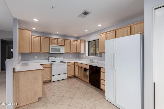 kitchen with white appliances, visible vents, light countertops, light brown cabinetry, and a sink