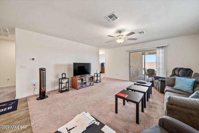 living room featuring ceiling fan and light hardwood / wood-style floors