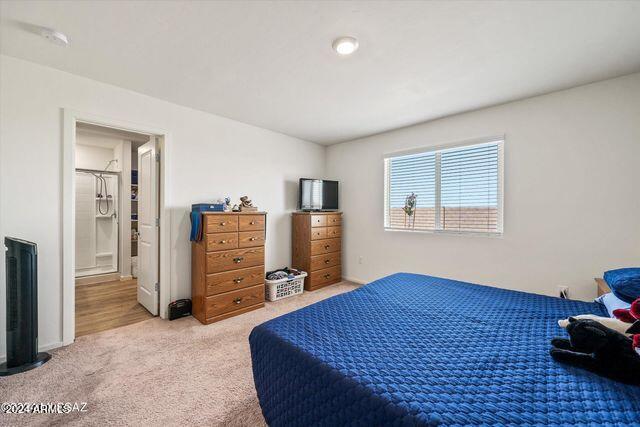 carpeted bedroom featuring ensuite bathroom