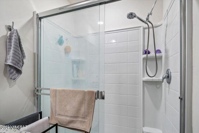 bathroom with a shower with shower door