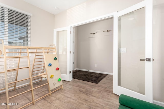 interior space with baseboards and wood finished floors
