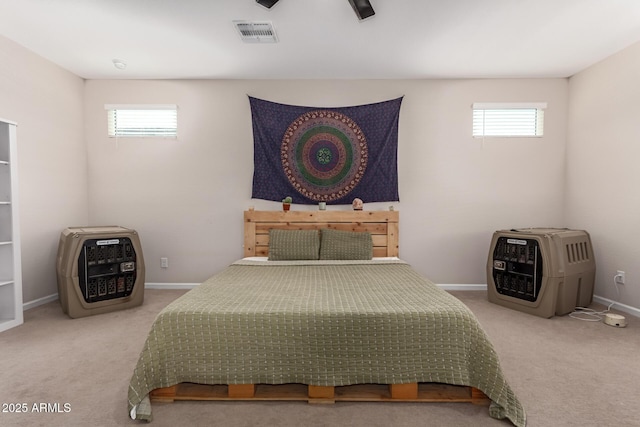 bedroom featuring visible vents, carpet flooring, baseboards, and heating unit