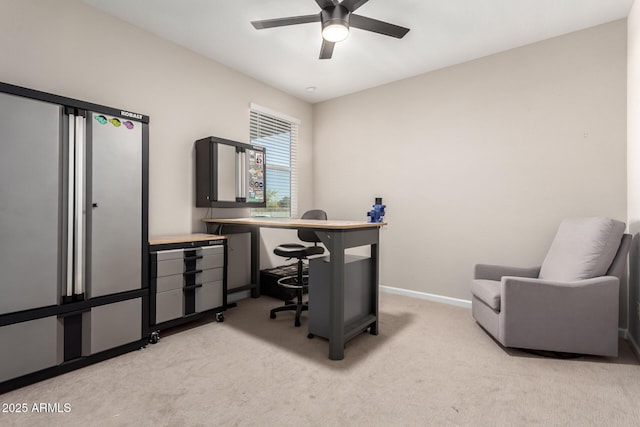 office featuring ceiling fan, light carpet, and baseboards