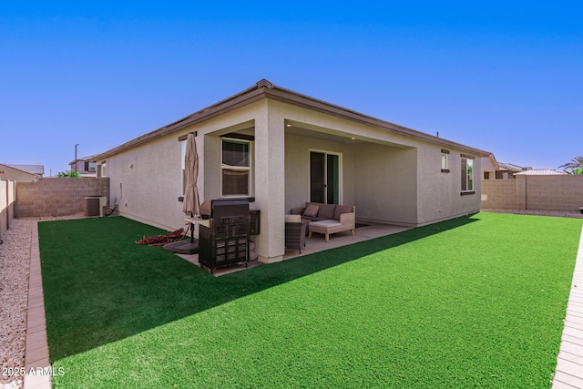 rear view of house with a fenced backyard, a patio, stucco siding, and a yard