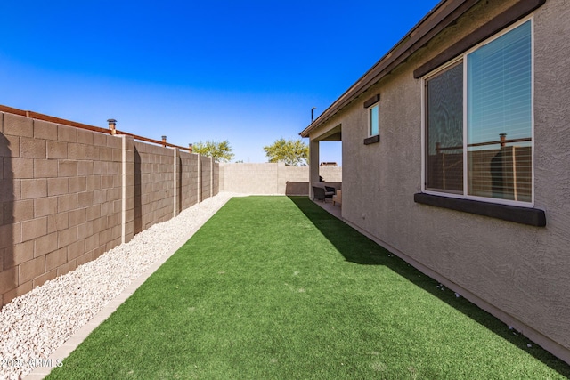 view of yard with a fenced backyard
