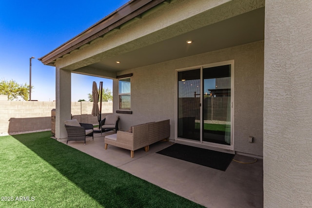 view of patio featuring fence and an outdoor hangout area