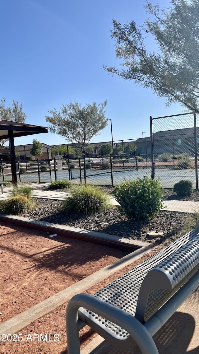 surrounding community featuring fence and a tennis court
