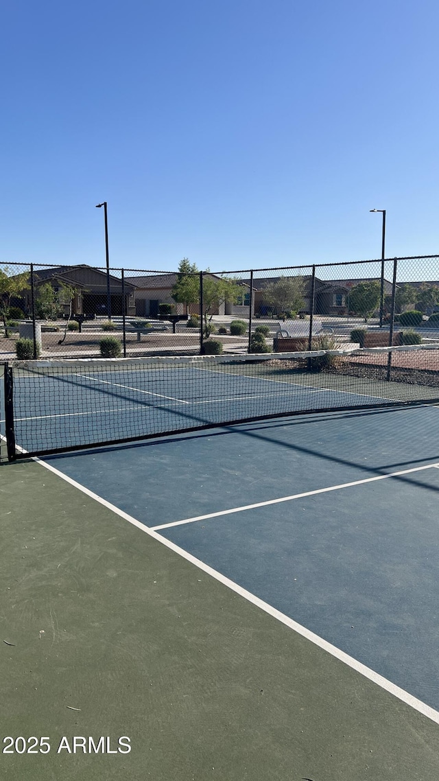 view of sport court with fence