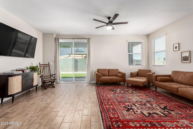 living area featuring light wood-style floors and ceiling fan