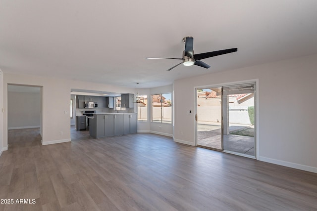 16609 S 41st St, Phoenix, AZ 85048 - unfurnished living room featuring dark wood-style floors, ceiling fan, and a chandelier
