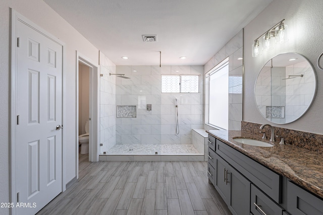 16609 S 41st St, Phoenix, AZ 85048 - bathroom with tiled shower, vanity, and wood finished floors