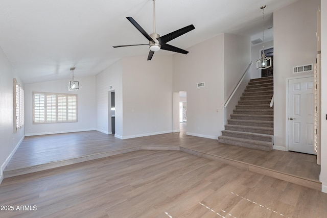 16609 S 41st St, Phoenix, AZ 85048 - unfurnished living room featuring stairs, light wood-style floors, high vaulted ceiling, and ceiling fan