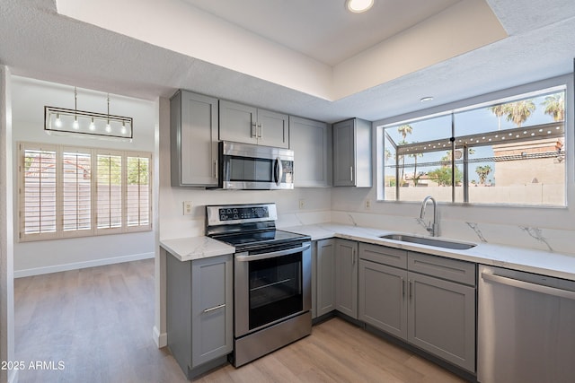 16609 S 41st St, Phoenix, AZ 85048 - kitchen featuring gray cabinetry, stainless steel appliances, light wood-type flooring, light stone countertops, and recessed lighting