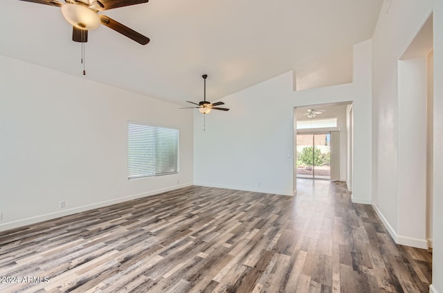 unfurnished living room with ceiling fan, wood-type flooring, and vaulted ceiling