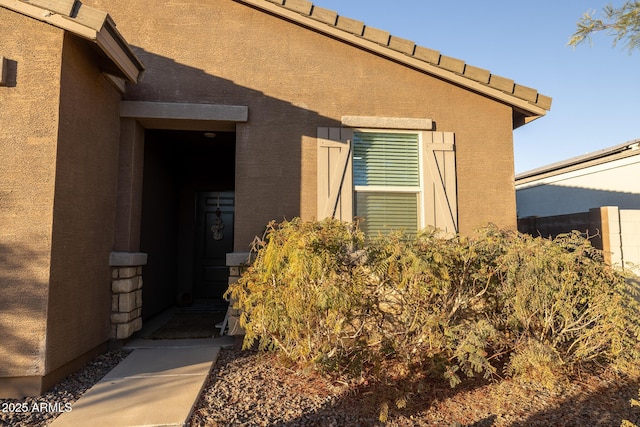 doorway to property with stucco siding