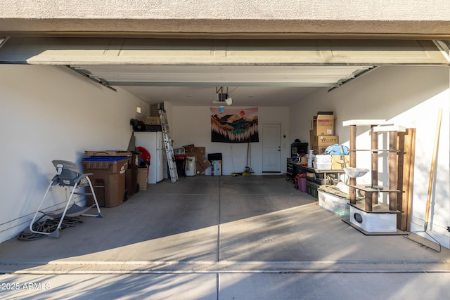 garage with concrete driveway and a garage door opener