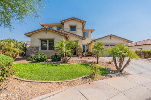 mediterranean / spanish-style house featuring a front lawn and a garage