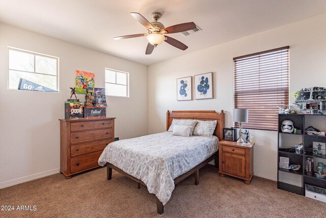 bedroom featuring ceiling fan and light carpet