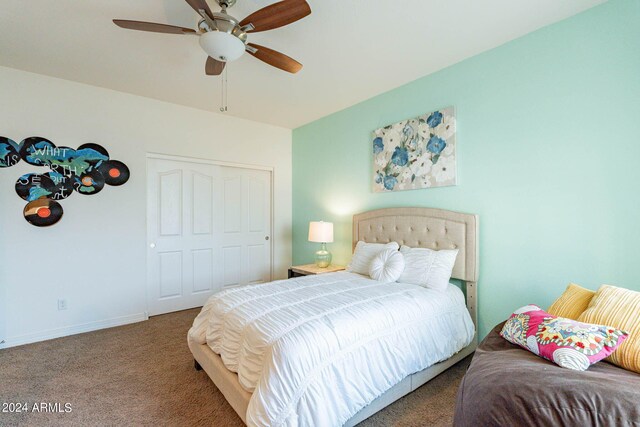 carpeted bedroom featuring a closet and ceiling fan