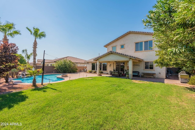 back of property with a patio area and a yard