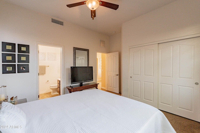 carpeted bedroom featuring ceiling fan, a closet, and ensuite bath