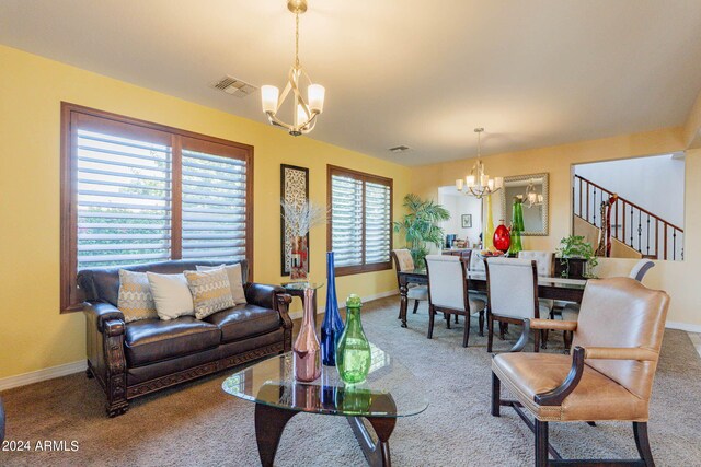 tiled living room featuring ceiling fan with notable chandelier