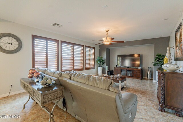 living room featuring ceiling fan and light tile patterned floors