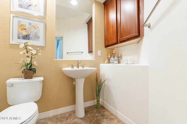 bathroom featuring toilet and tile patterned floors